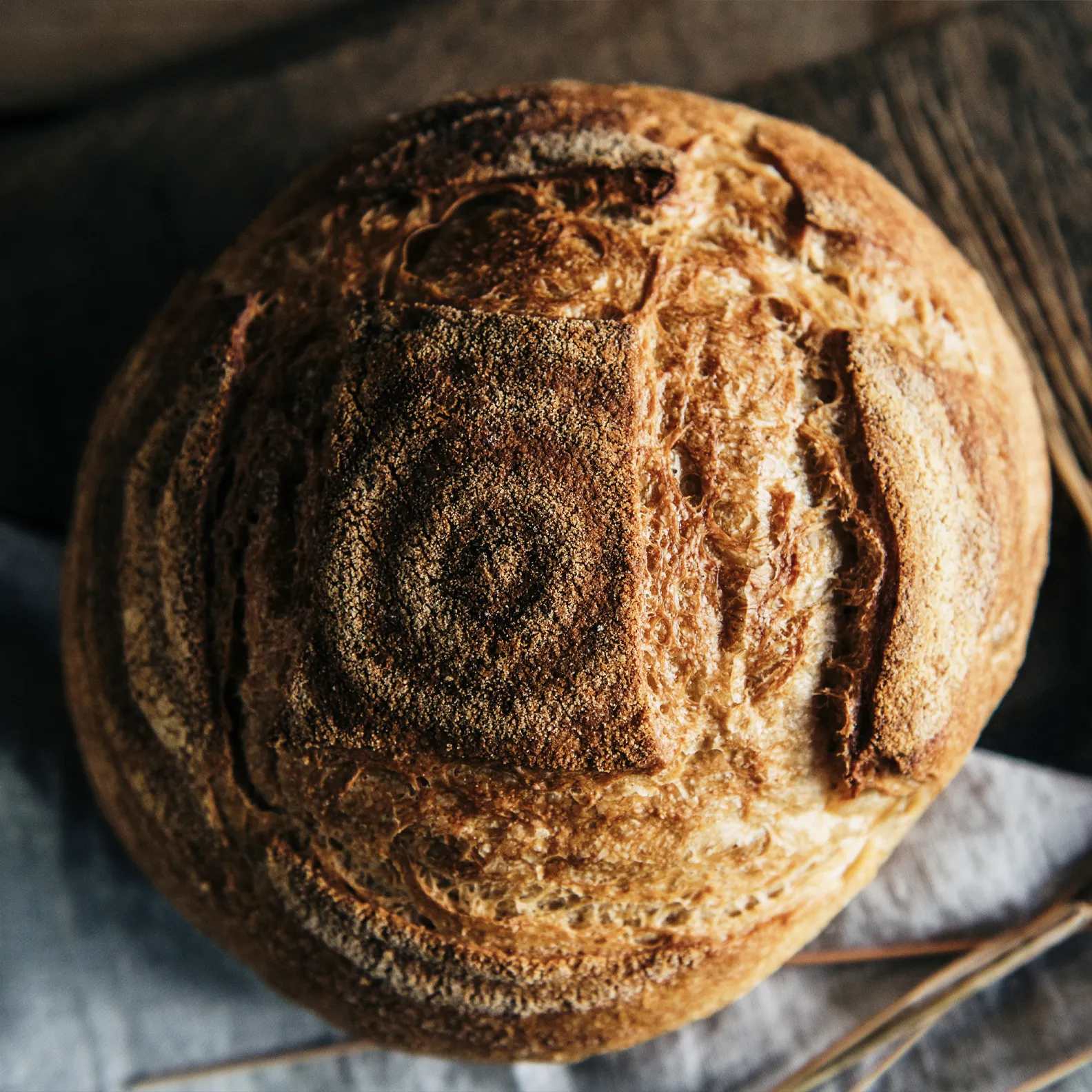 A round hand-scored sourdough loaf